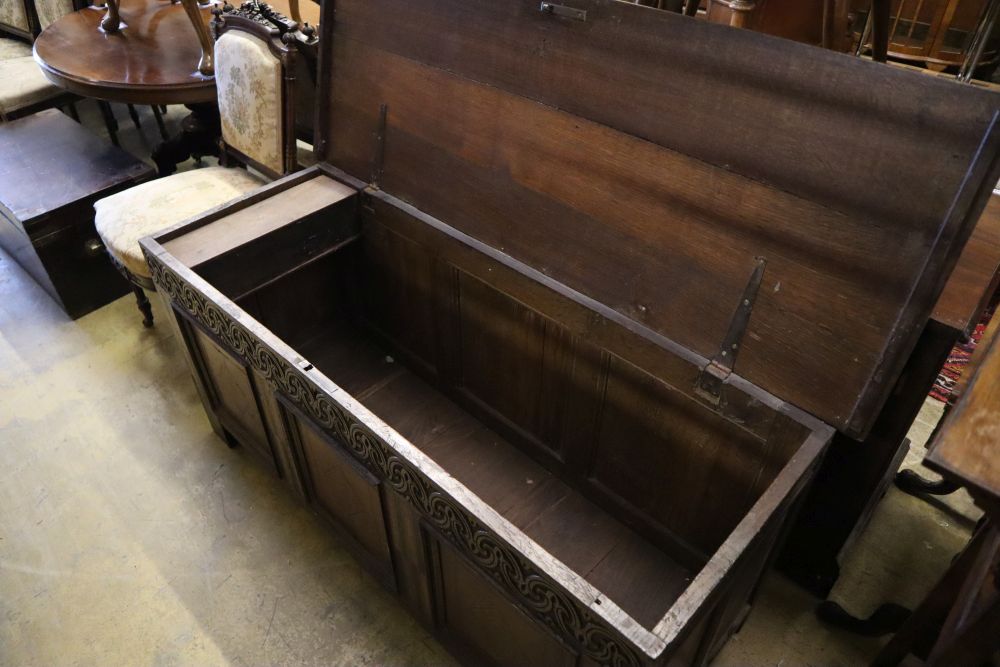 A 17th/18th century inlaid oak coffer with panelled front and planked top, width 145cm depth 53cm height 66cm